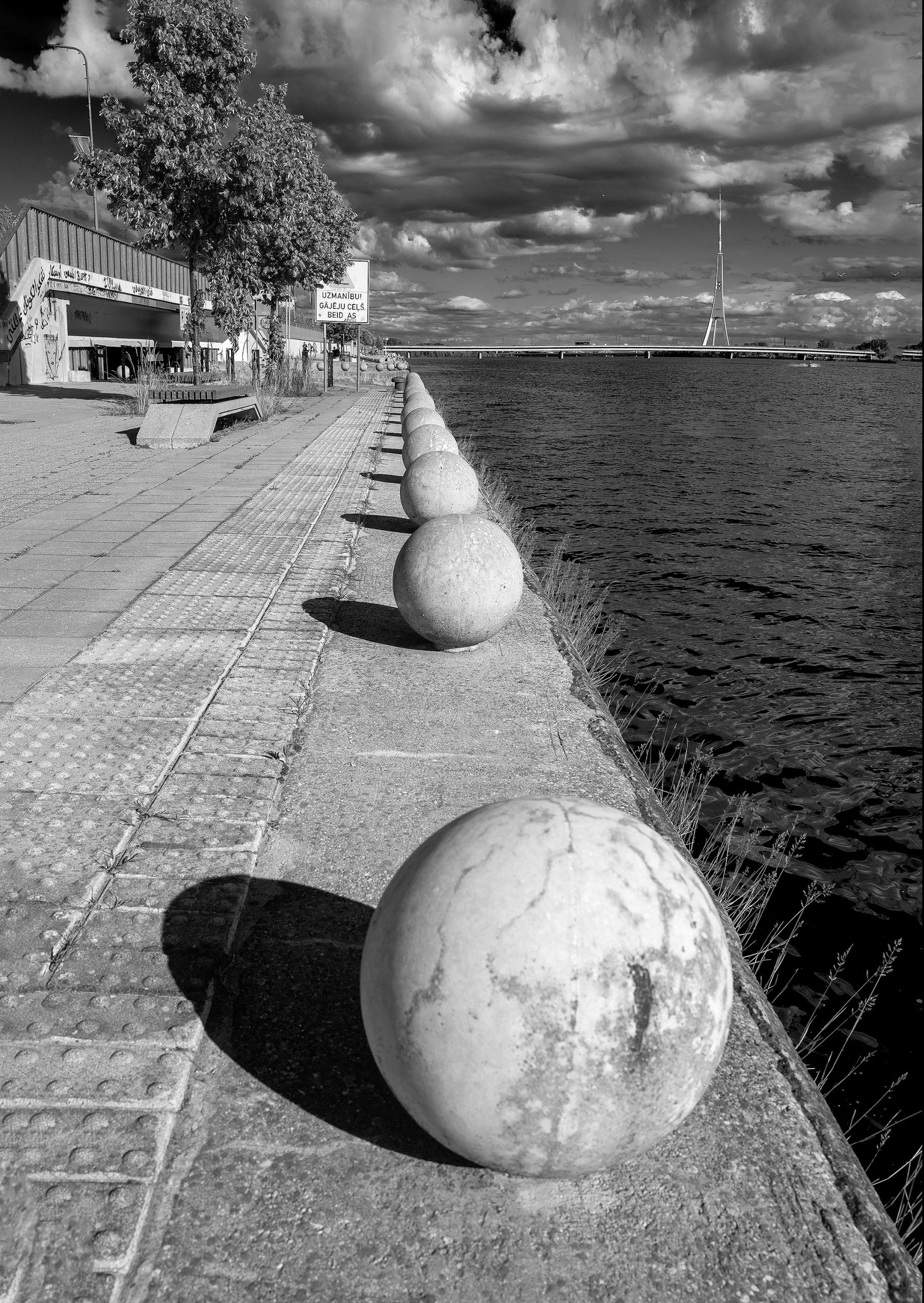 The river promanade disappears into the clouds and river